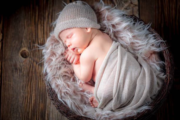 istock Lovely newborn baby sleeping on a fluffy blanket 856245350
