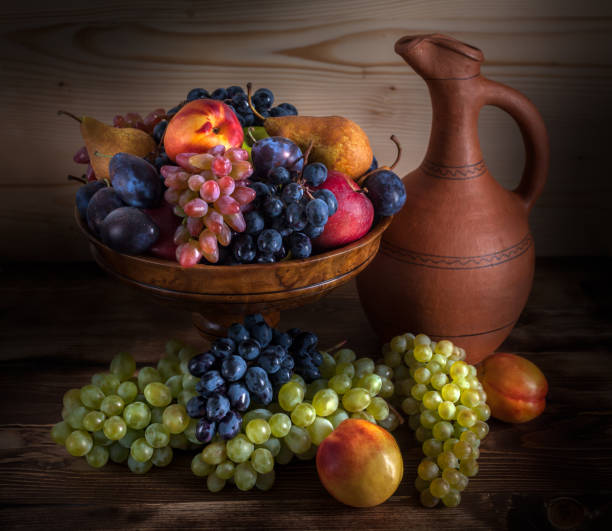 istock autumnal fruit still life with Georgian jug on rustic wooden table background 856252916