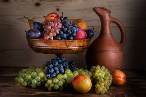 istock autumnal fruit still life with Georgian jug on rustic wooden table background 856253018