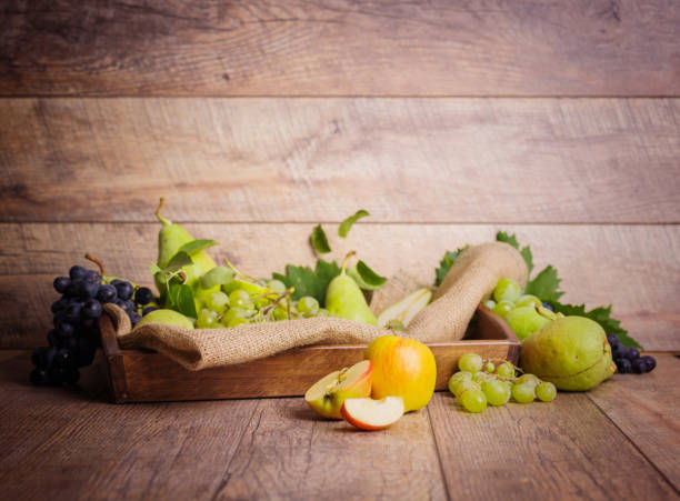 istock Fruits in a box on a rustic background. Green grape, pears and sweet apples. Harvest concept. Copy space. 856253146
