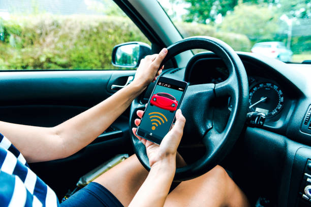 istock Mobile app connects wirelessly to car as women sits in the driver seat 856269870