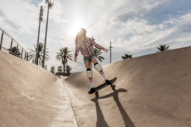 istock Young woman skating in skateboard park 856270056