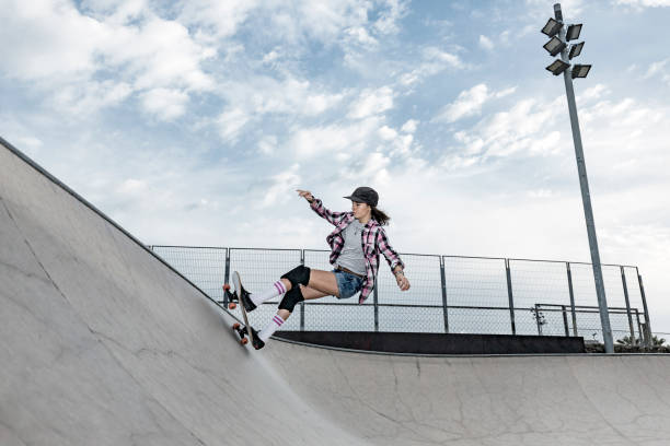istock Young woman skating in skateboard park 856270098