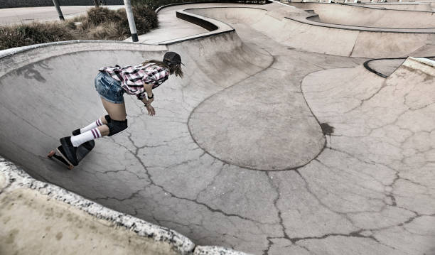 istock Woman skateboarding in skateboard park 856270168