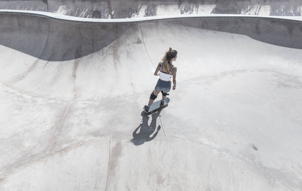 istock Young woman skateboarding in skateboard park 856270202