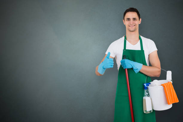 istock Male Janitor Holding Cleaning Equipments 856279866