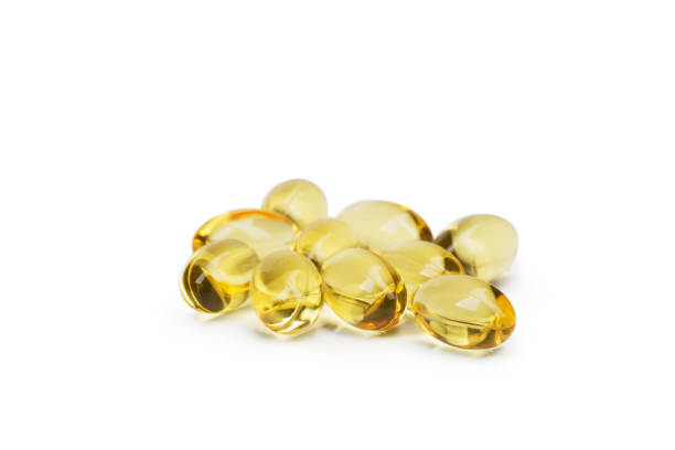 istock Cod liver oil omega 3 gel capsules or pils isolated on a white background. A group of transparent fish oil tablets. 856285594