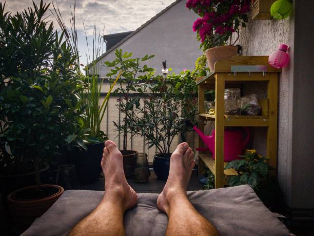 Low Section of a man relaxing on a balcony. POV