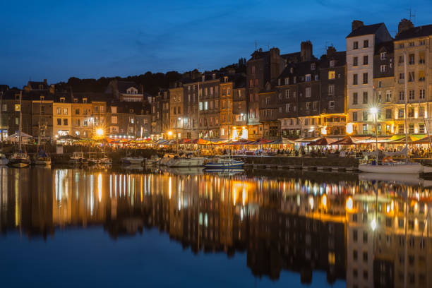istock Harbor Honfleur at night with ships and restaurants, France 856295144
