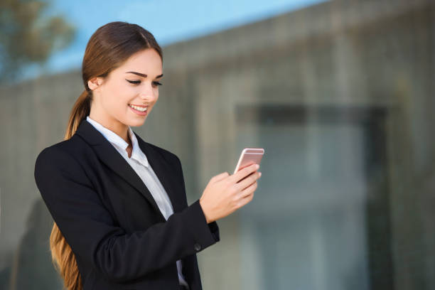 istock Beautiful young businesswoman is using an application in her smart phone device to send a text message 856304068