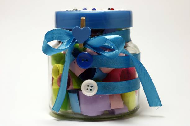 istock decorative jar with colored notes with congratulations on the holiday, isolated on white background 856308306