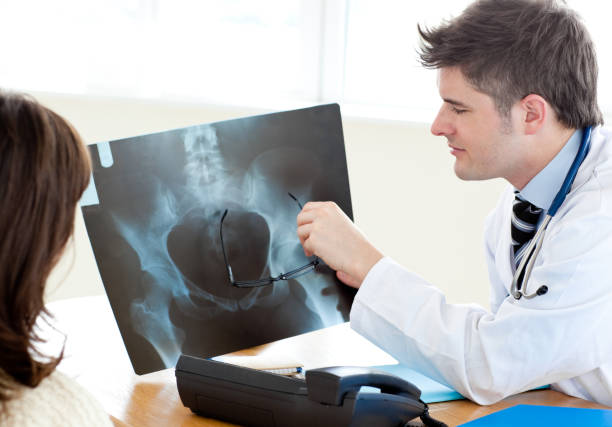 istock Handsome doctor analyzing an xray with a female patient 856308324