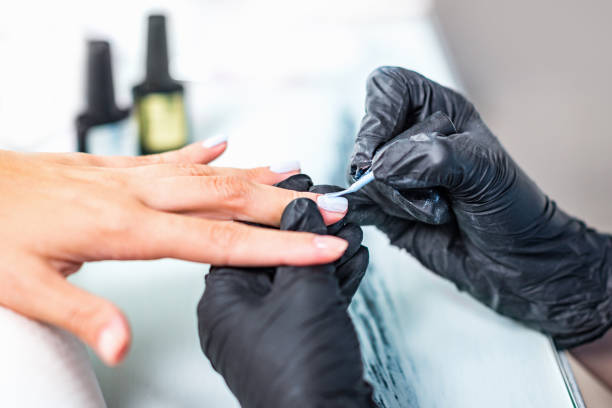 istock Manicure, applying nail polish in beauty salon 856309616