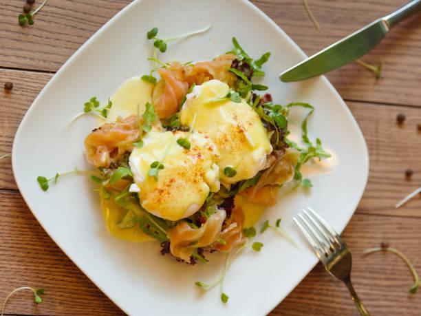 istock Top view of poached eggs. Cafe supper with knife and fork on a b 856311780