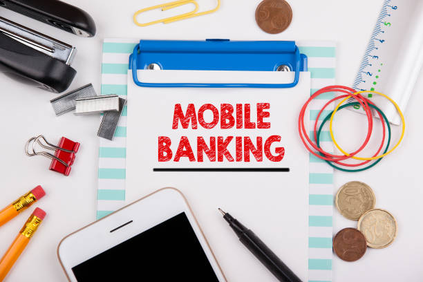 istock Mobile banking concept. Office desk with stationery and mobile phone 856315044