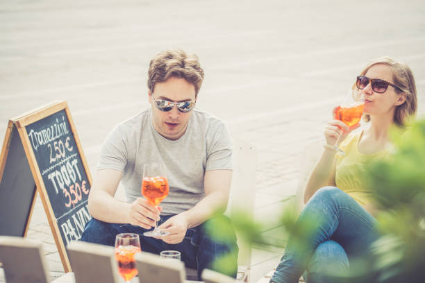 istock Couple drinking cocktail outdoors 856315252