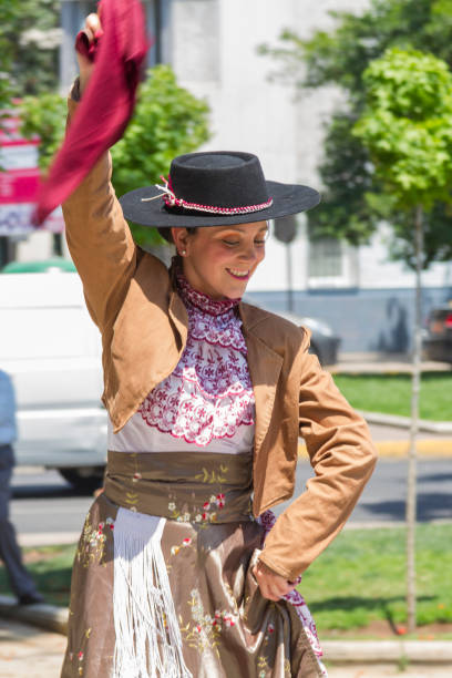 Celebrations of Chile's Independence Day Santiago de Chile, Chile - September 18, 2017: 'Cueca' Chilean typical dance performed by woman in a National day on Chile at Parque Forestal, Santiago's downtown. chilean ethnicity stock pictures, royalty-free photos & images