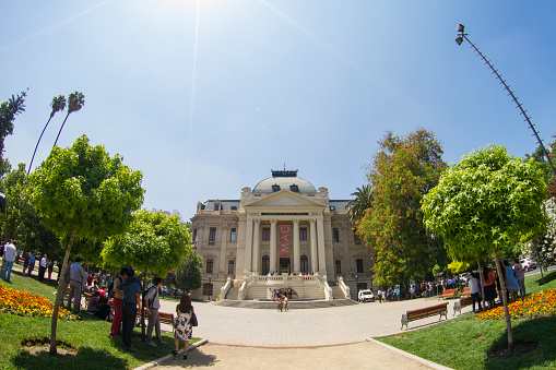 San Francisco, CA, USA - July 12, 2023: Asian Art Museum front facade with its columns and colorful banners promoting its treasures. 2 Asian statues up front