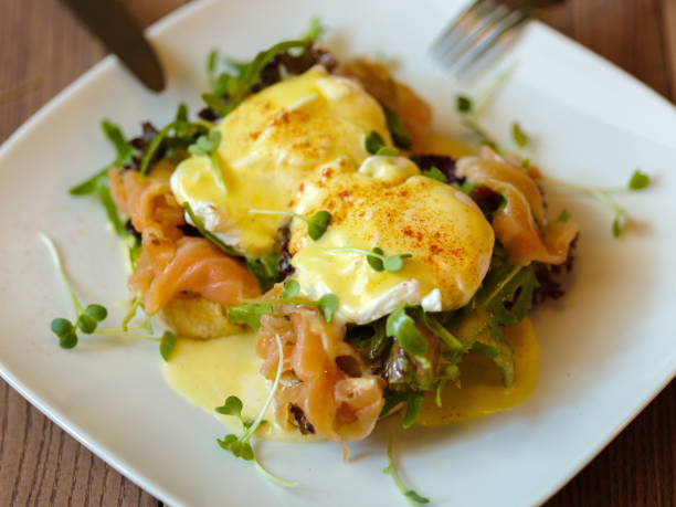 istock Poached eggs on a plate. Close-up of baked spicy eggs with salmo 856317936