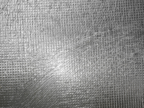Shiny rippled metal foil surface close up