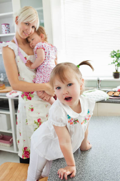 istock Attractive woman playing with her daughters 856327566