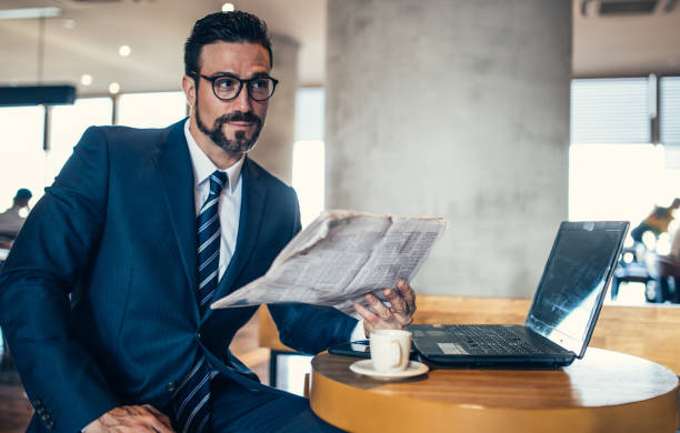 istock Businessman reading news in cafe 856331044