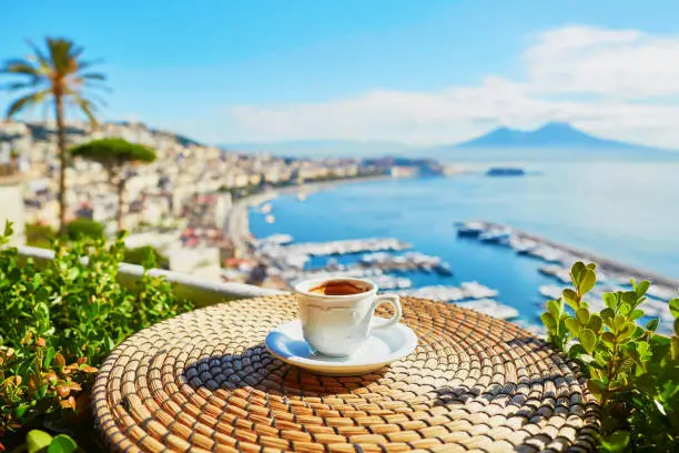 Cup of fresh espresso coffee in a cafe with view on Vesuvius mount in Naples, Campania, Southern Italy