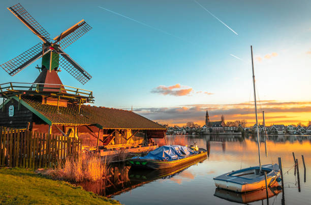 istock A windmill and boat on a lake at sunset 856338274