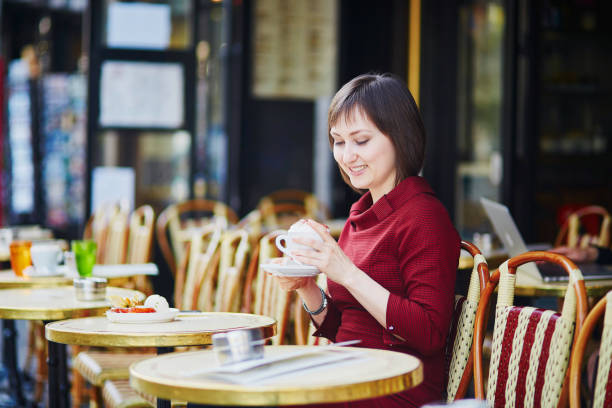 istock Woman drinking coffee in Parisian outdoor cafe 856339284