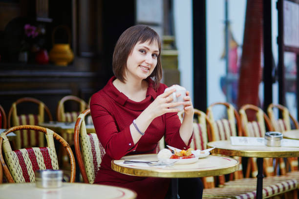 istock Woman drinking coffee in Parisian outdoor cafe 856340516