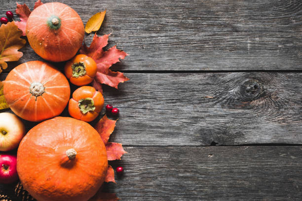 istock Thanksgiving background with pumpkins, apples and fallen leaves on wooden table 856342126