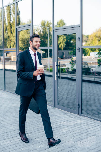 istock businessman walking with coffee to go 856342772