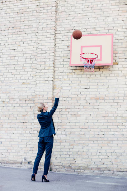 istock businesswoman playing basketball 856342814