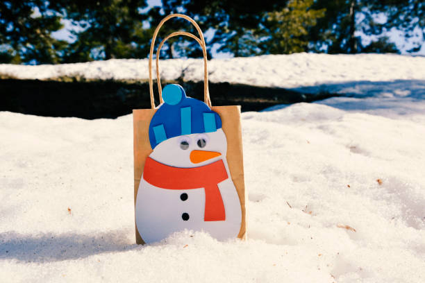 istock Paper Gift Box Package of a Christmas Snowman in the Snow 856349672