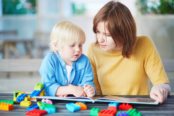 Young mother reading book to her son