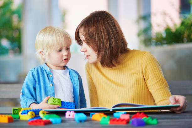 istock Young mother reading book to her son 856349968