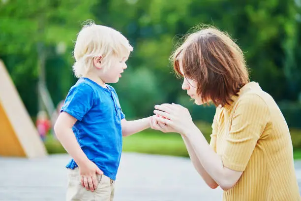 Photo of Mother comforting son after he injured his hand