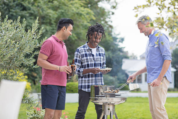 istock Smiling multi-ethnic male friends enjoying in yard 856358670