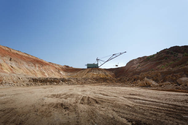 istock One-tower metal mobile crane on a blue sky background. An industrial moving machine in the foundation pit. Copy space. 856363098