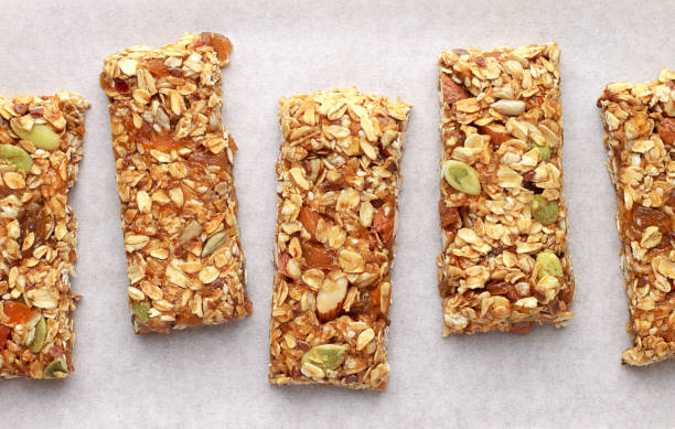 istock Homemade granola bars on white baking paper. 856365846