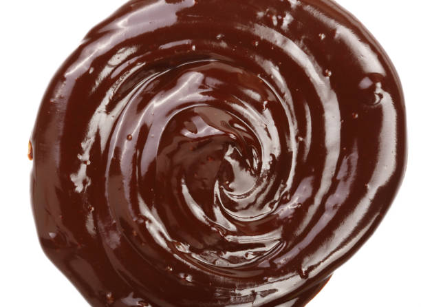 istock Hot melted chocolate pouring isolated on white background, top view 856372710
