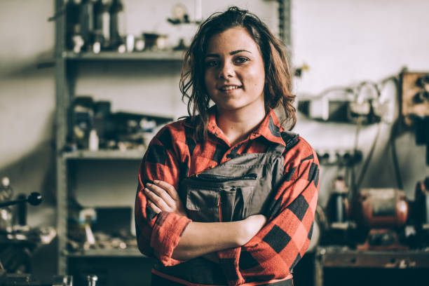 Charming girl mechanic One woman, working in workshop, she has skills. woman wearing tool belt stock pictures, royalty-free photos & images