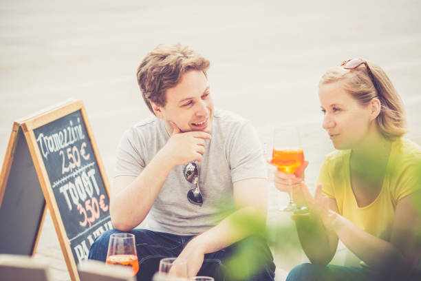 Couple drinking cocktail outdoors