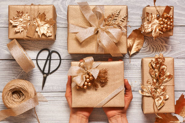 istock Woman wrapping christmas presents over wooden background 856373368