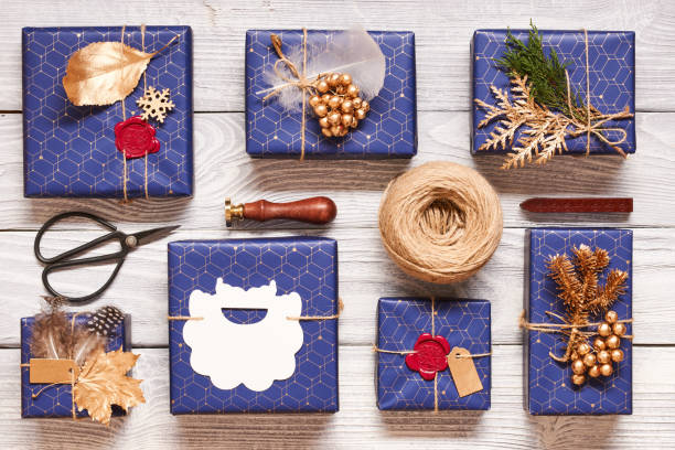 istock Christmas presents on wooden background 856373372