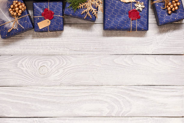 istock Christmas presents on wooden background 856375808