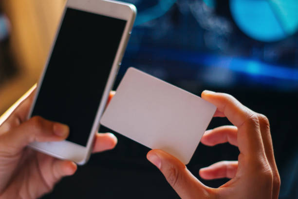 istock Close-up woman's hands holding a credit card and smartphone 856376152