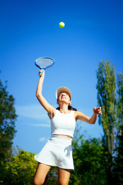 istock Young woman playing tennis 856379070