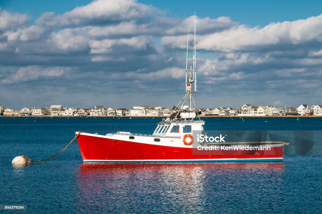 Red Lobster Boat A red lobster boat is moored off Cedar Point in Scituate, Massachusetts on a cold January afternoon. Massachusetts Stock Photo