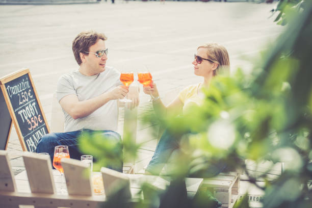 istock Couple drinking cocktail outdoors 856385408